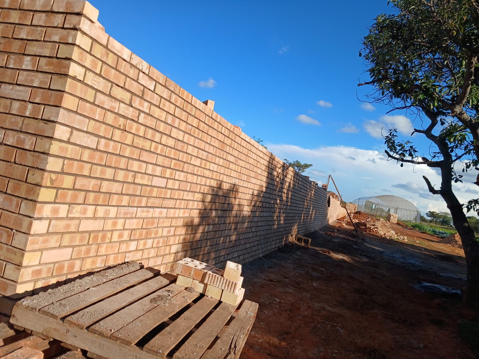 Bricklayers building walls with steel lintels for door openings