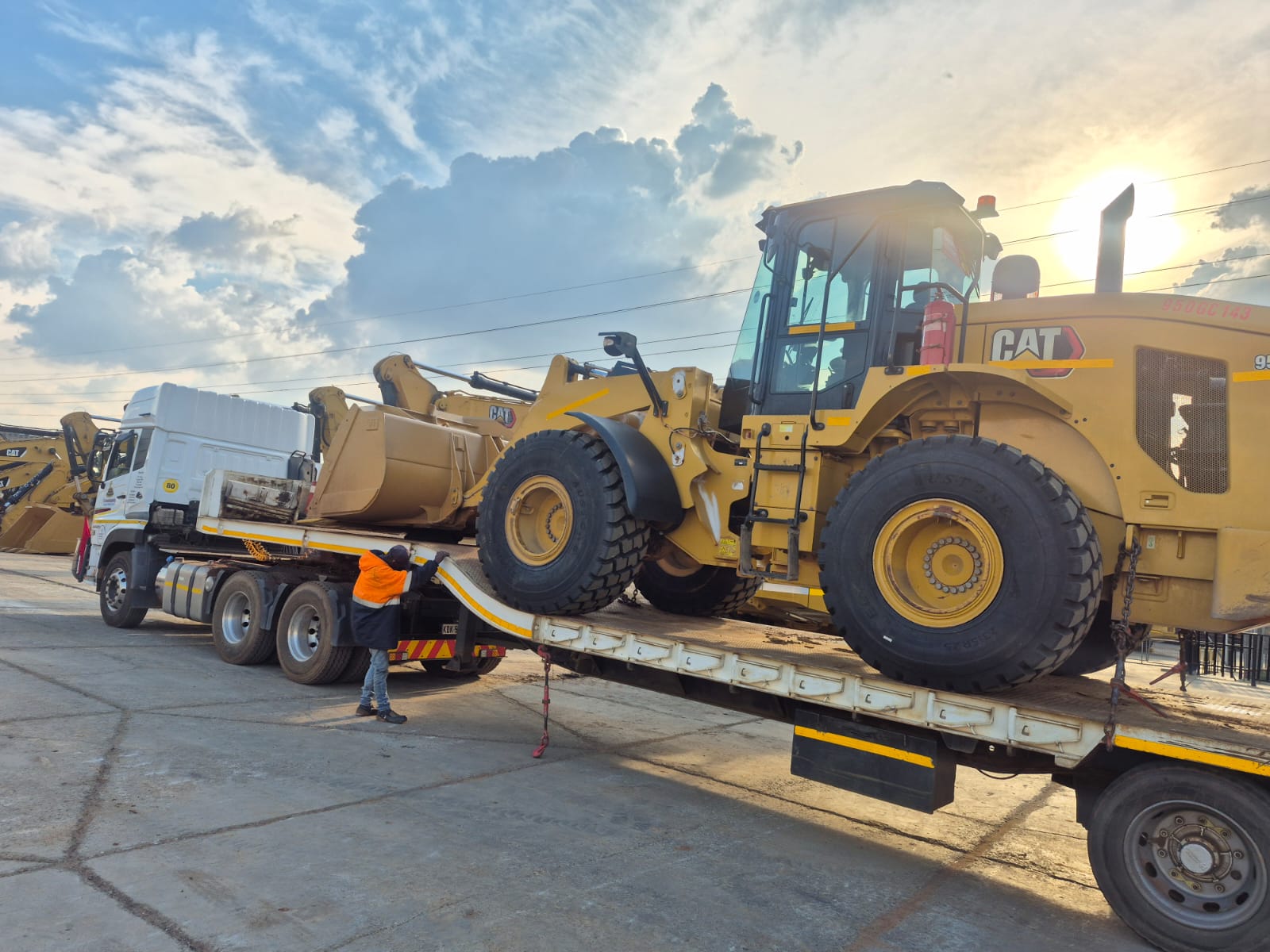 CAT wheel loader being delivered on a lowbed trailer