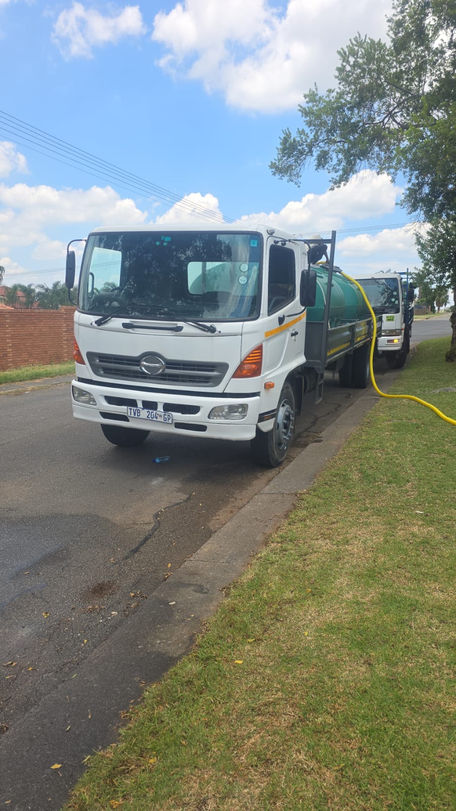 Water tanker delivering water on site via hose
